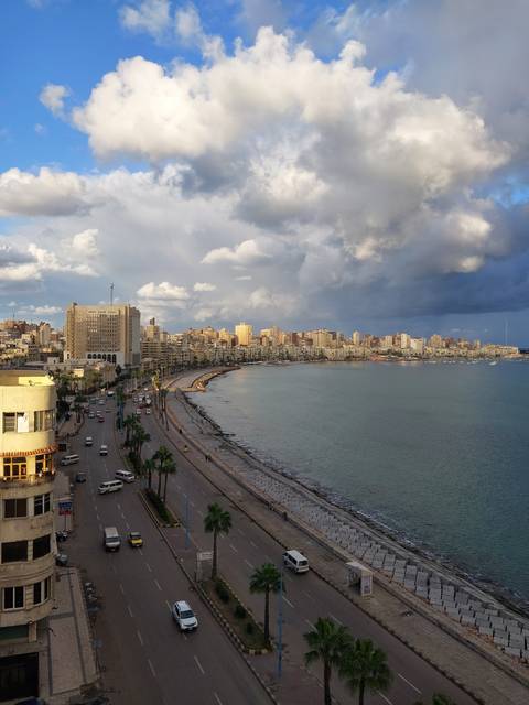 Scenic view of a coastal city with a seawall.