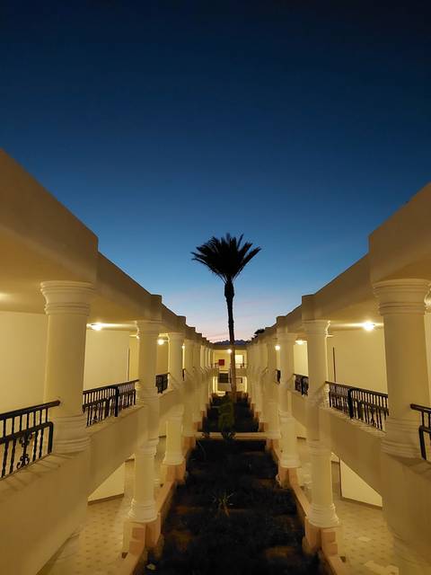 Corridor with columns leading towards an open view.