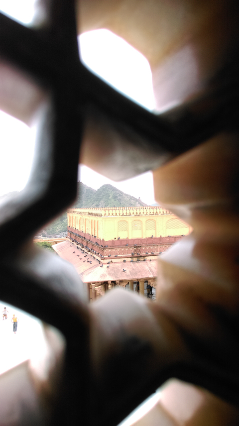 View through a carved window of a historic building.