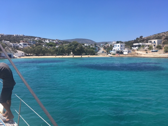 Coastal village with sandy beaches and clear blue water.