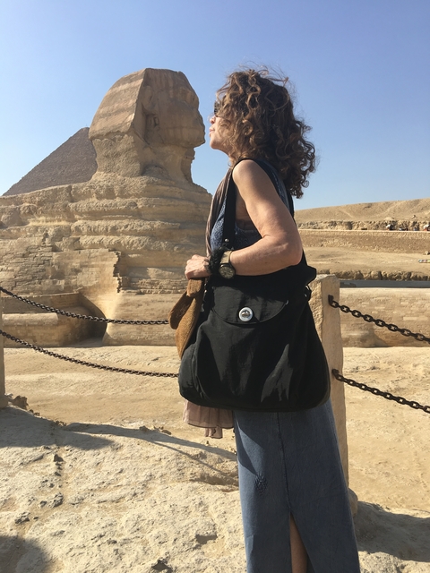       Close-up of a woman standing in front of the Sphinx.
  