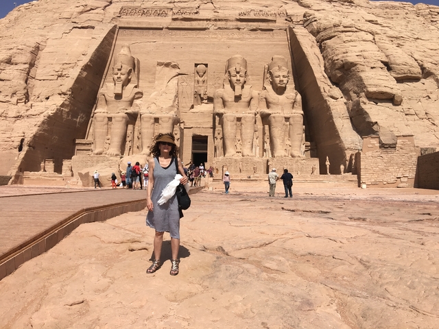       Large statues of pharaohs carved into rock at Abu Simbel temple.
  