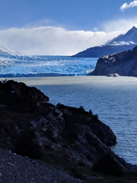       Blurry image of a glacier meeting the sea.
  