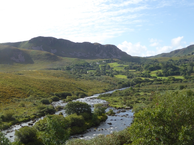 Scenic river flowing through lush hills.