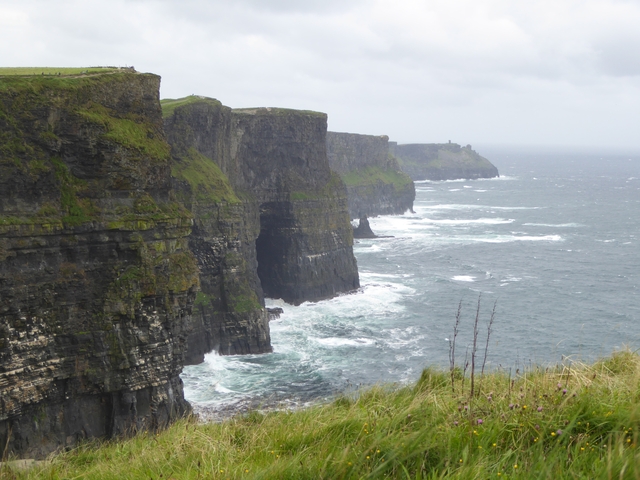 Cliffs overlooking a turbulent sea.
