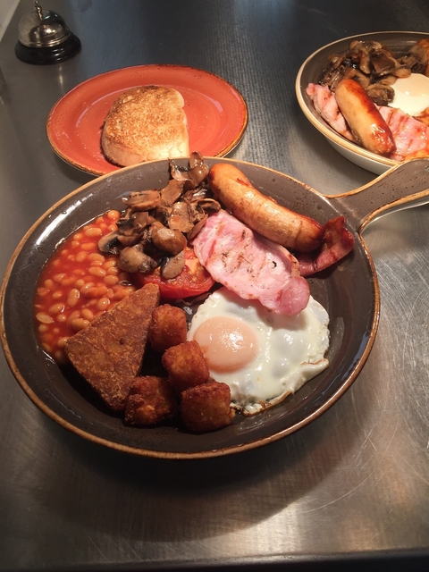       Traditional English breakfast with beans, eggs, and sausage.
  
