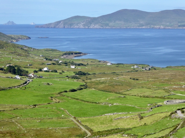 Coastal landscape with distant hills and scattered houses.