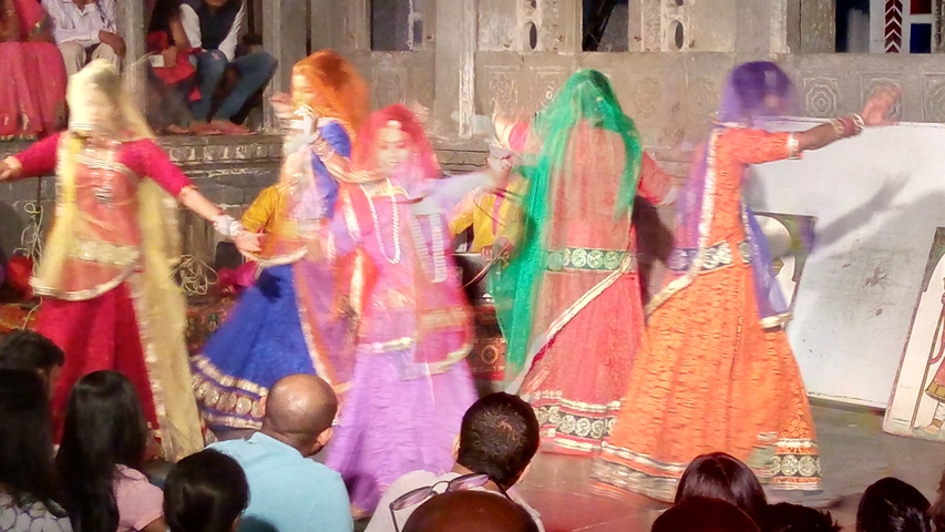 Traditional dance performance in colorful attire.