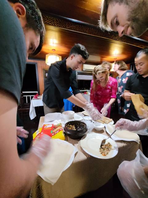 People participating in a cooking activity with various dishes.
