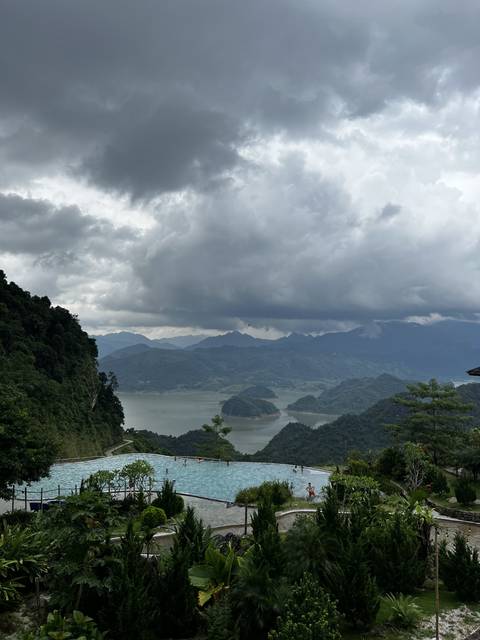 Overcast sky above a valley view with a pool in the foreground.