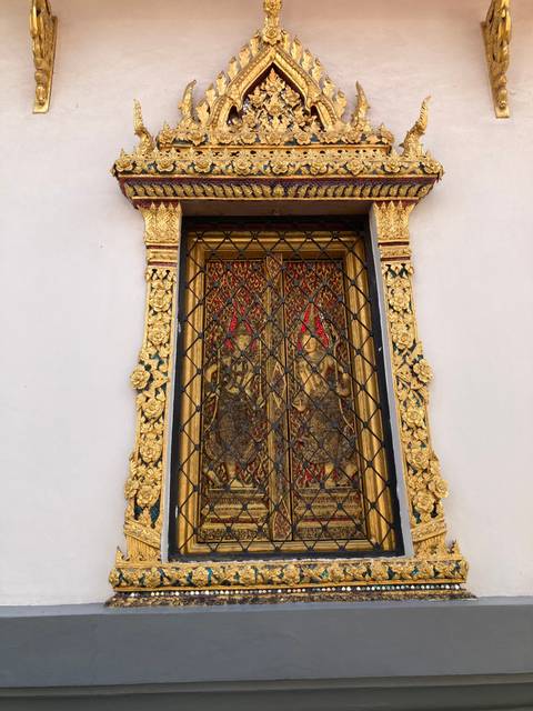 Intricate window with gold decorative elements.