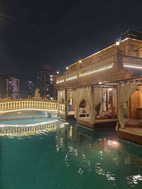       Illuminated boat on water body at night.
  