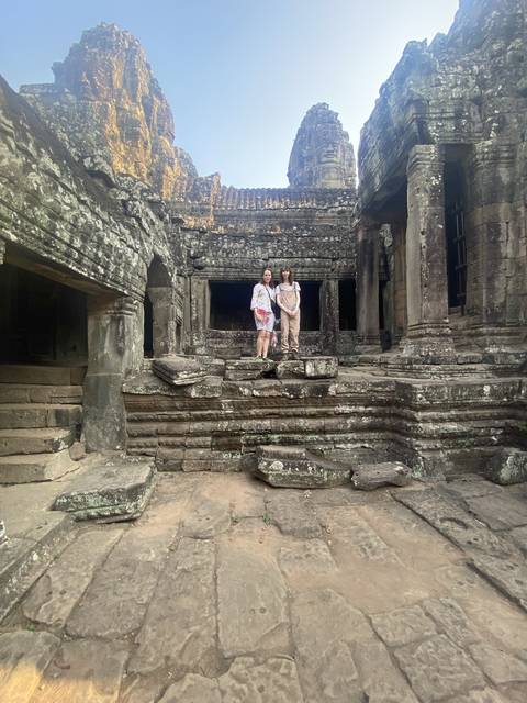       Tourists climbing stairs of a historic ruin.
  