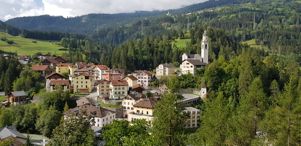 Picturesque village nestled in lush green hills.