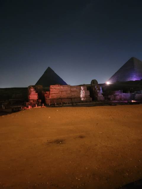 Ancient monumental structures illuminated at night.