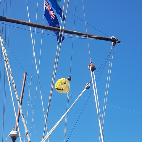       Parasailing setup with smiling parachute.
  