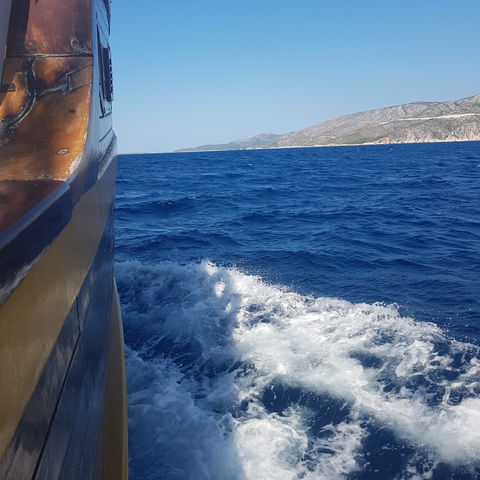 View of the sea with waves splashing against a boat.