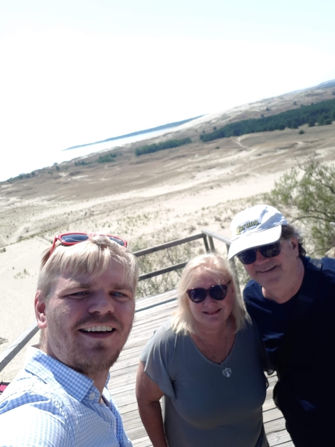 Selfie with three people on a sand dune viewpoint.