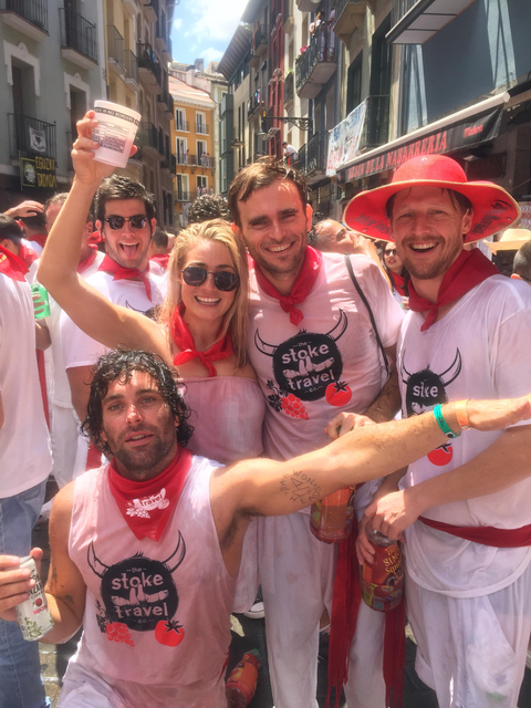 Group of people celebrating with red scarves.