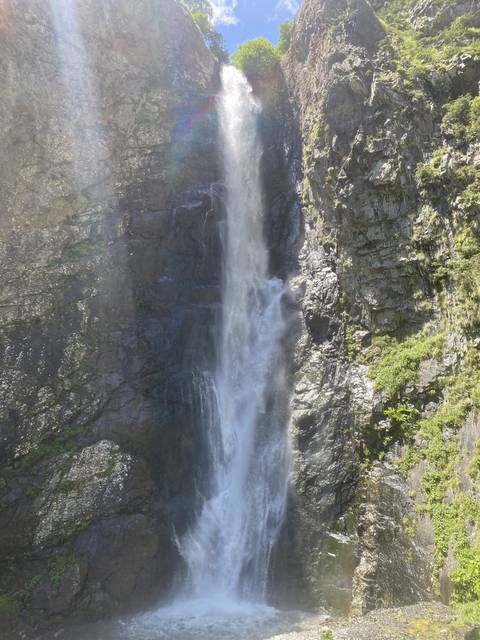       A waterfall cascading down a rocky cliff.
  