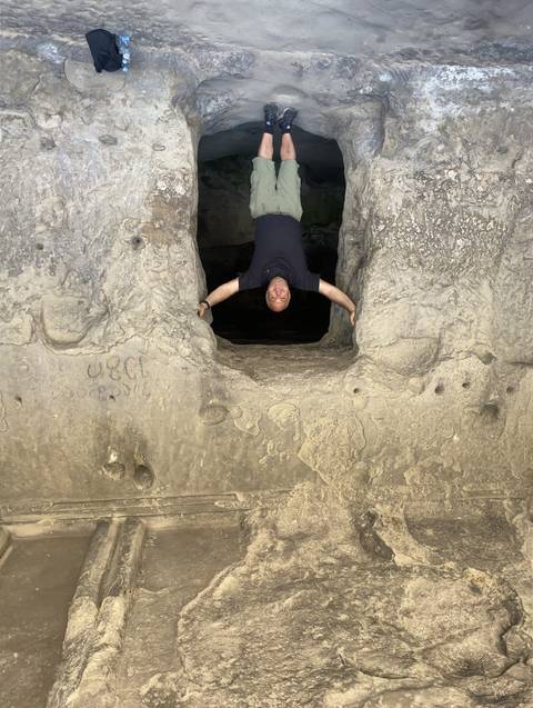 A person standing between rock formations.