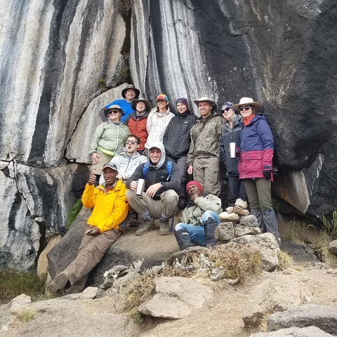 Group of hikers posing on a rocky mountain.