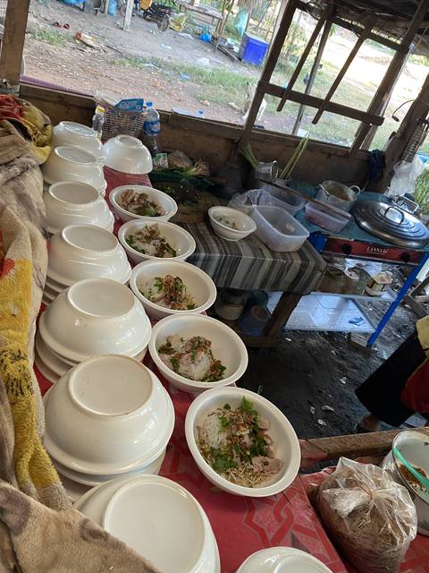       Plates of prepared food on a cluttered table.
  