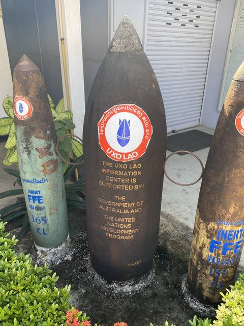 A large upright bomb artifact with descriptive text.