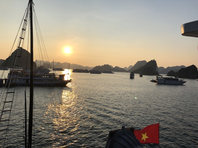 Sunset view over a bay filled with boats.