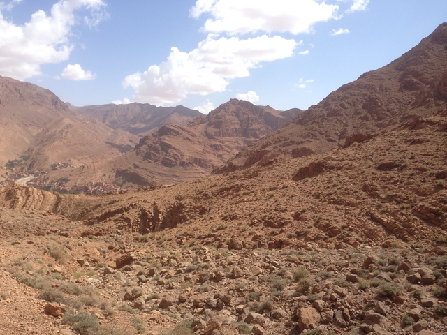      Arid rocky landscape with distant mountains.
  