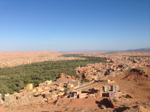       Overlooking a sprawling desert town with clear skies.
  