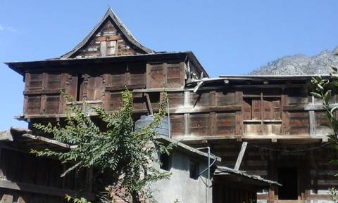 Traditional wooden structure with greenery.
