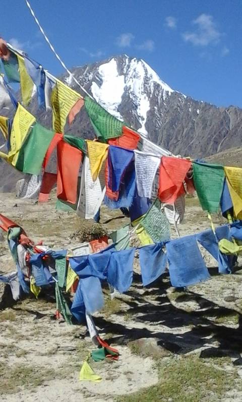Colorful prayer flags in a mountainous area.