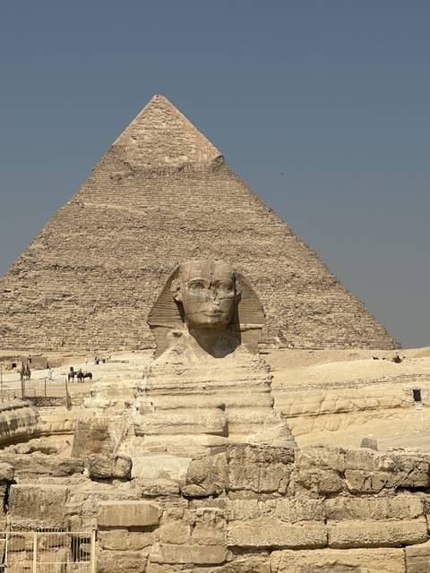 The Sphinx and Pyramid in Giza with tourists.