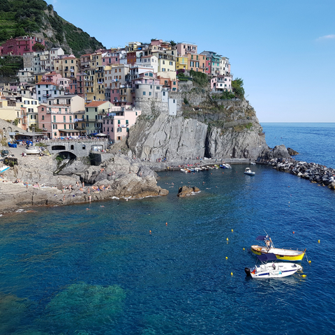 A picturesque coastal village with colorful houses built on cliffs.