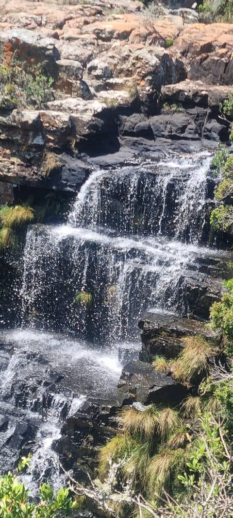 Waterfall cascading down rocky cliffs.