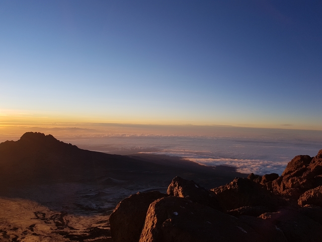 A stunning mountain view during a sunrise with rock formations.