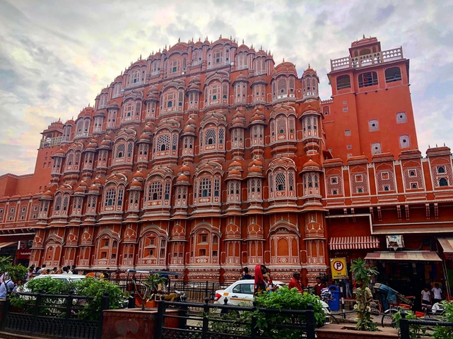 The Hawa Mahal, a pink sandstone palace with intricate windows.