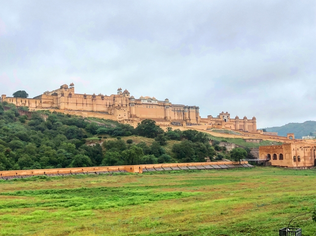 An expansive fort complex on a lush green hill.
