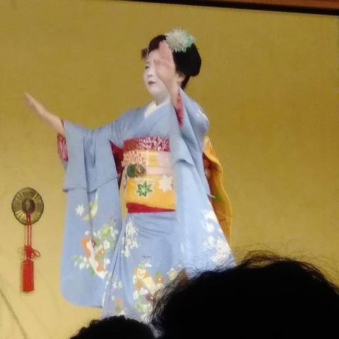 Performing artist in traditional attire on stage.