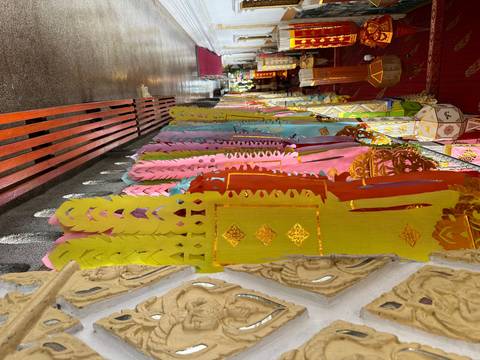 Colorful paper banners hanging from a ceiling in a corridor.