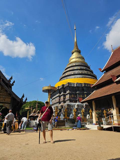 Person walking in front of a large stupa.