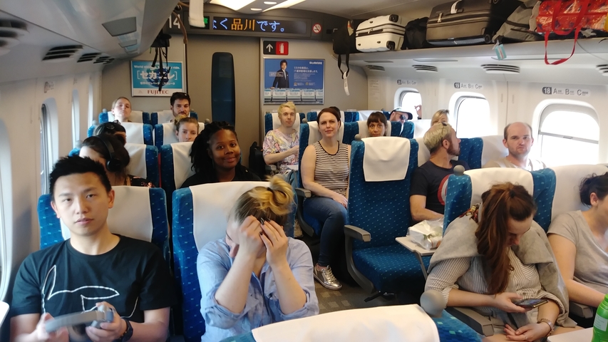       Passengers seated inside a train carriage.
  