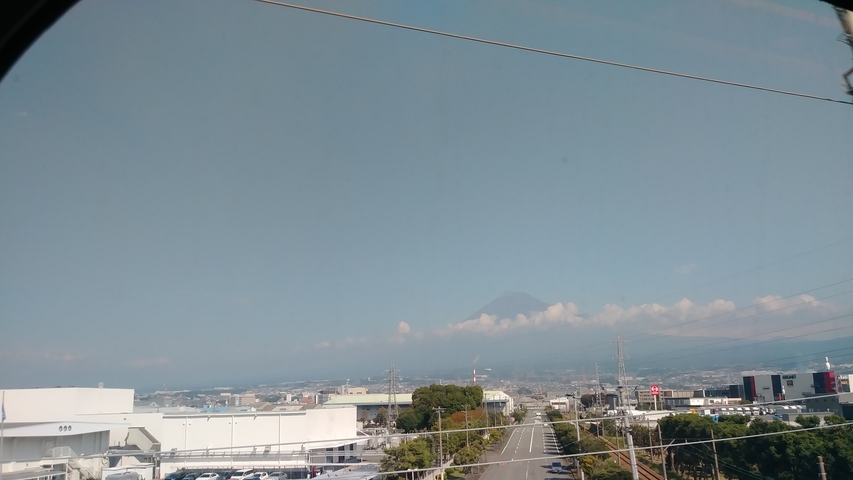       View of a cityscape with Mount Fuji in the background.
  