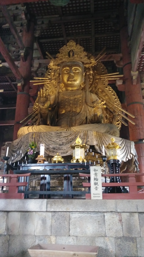 Blurred view of a large golden Buddha statue.