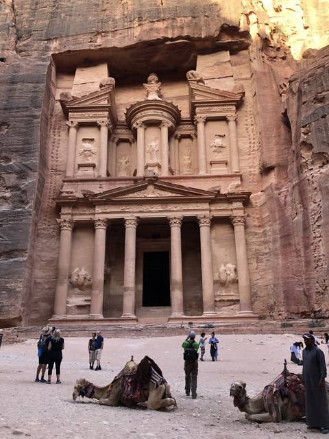 Tourists and camels in front of the Treasury in Petra.