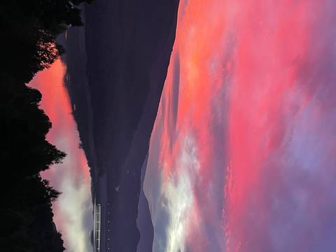 Vibrant sunset over mountains and a river.