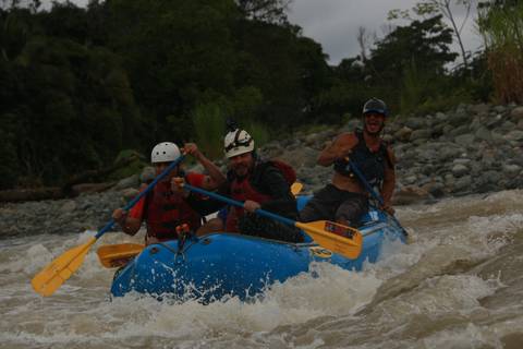       Three people rafting in a river, showing excitement and teamwork.
  