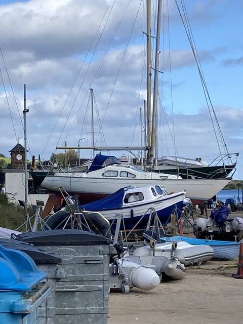       Boat and various equipment in a marina.
  