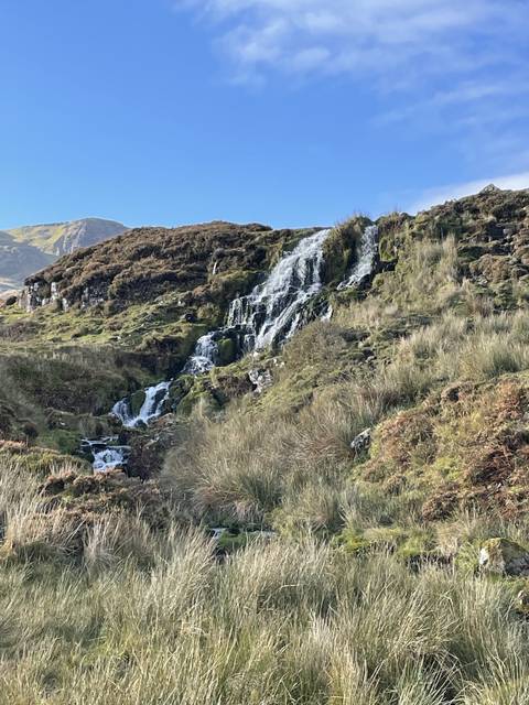      Waterfall cascading down rocky cliffs.
  